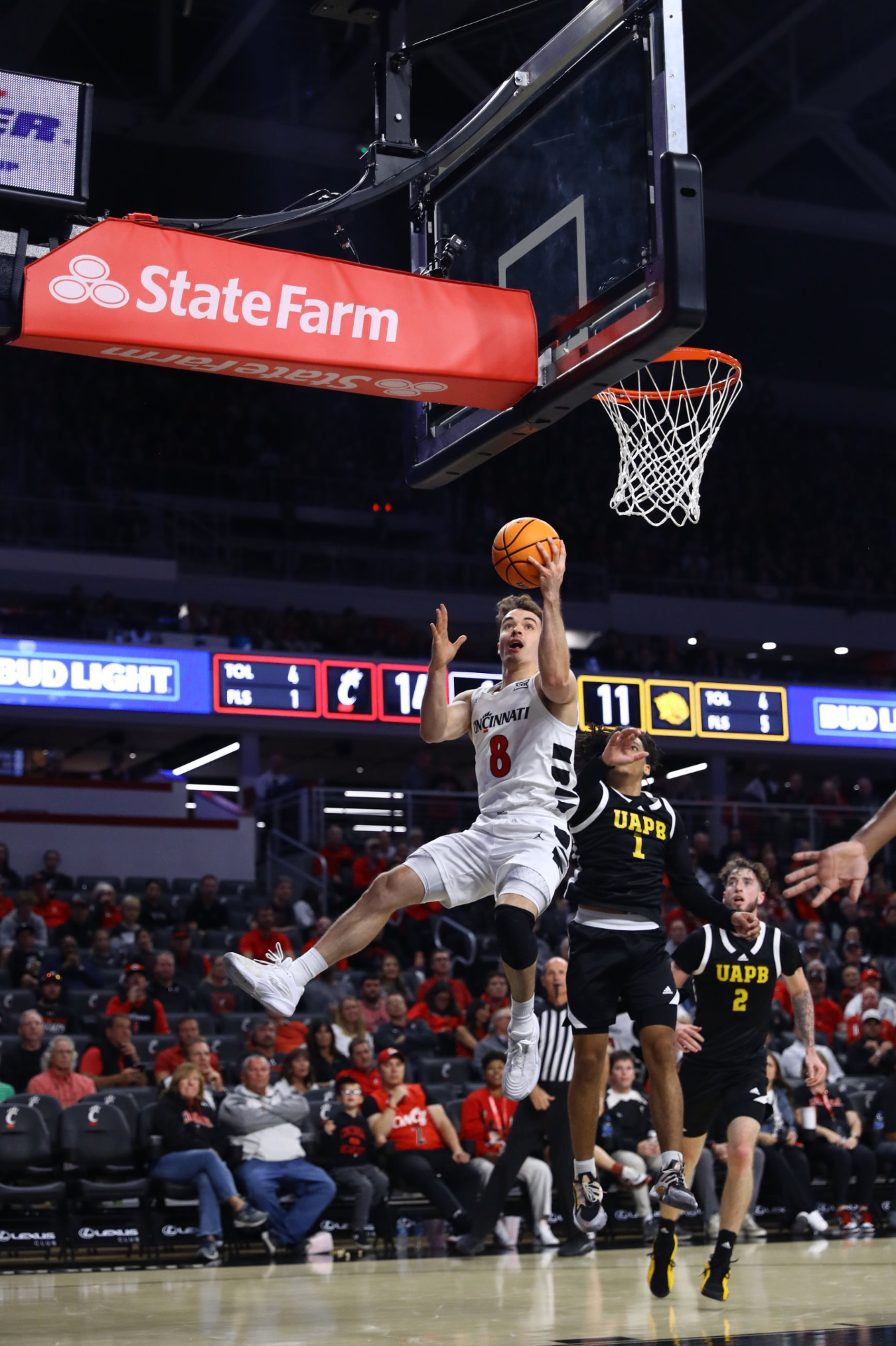 Connor Hickman finishing a layup in a Cincinnati uniform